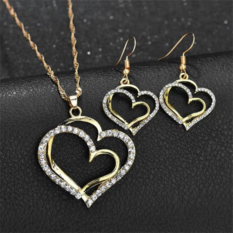 CONJUNTO CADENA Y ARETES DOBLE CORAZÓN DORADO INCRUSTACIONES LAVANDA