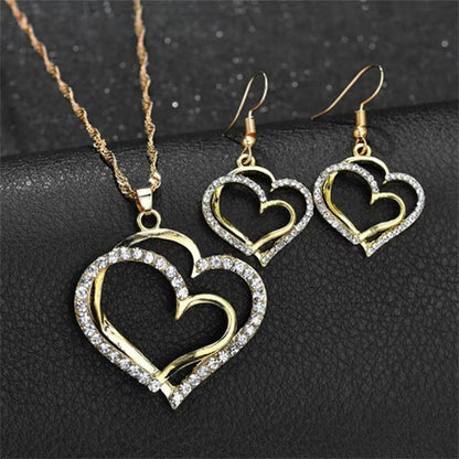 CONJUNTO CADENA Y ARETES DOBLE CORAZÓN DORADO INCRUSTACIONES LAVANDA