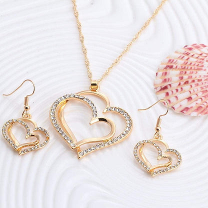 CONJUNTO CADENA Y ARETES DOBLE CORAZÓN DORADO INCRUSTACIONES LAVANDA